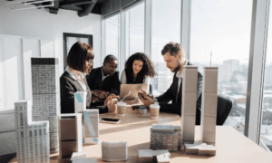 Four people working with some building mockups.