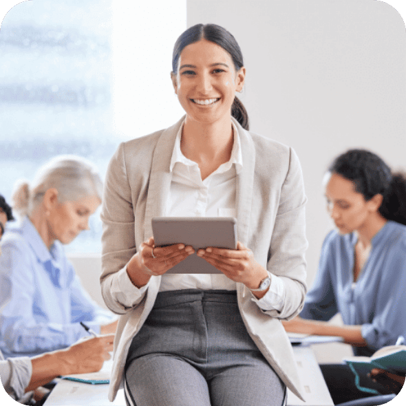 Smiling girl sitting on a table and holding a template.