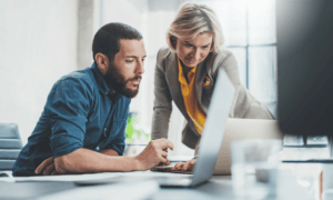 Two people looking at a computer