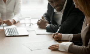 Two people looking at a piece of paper.