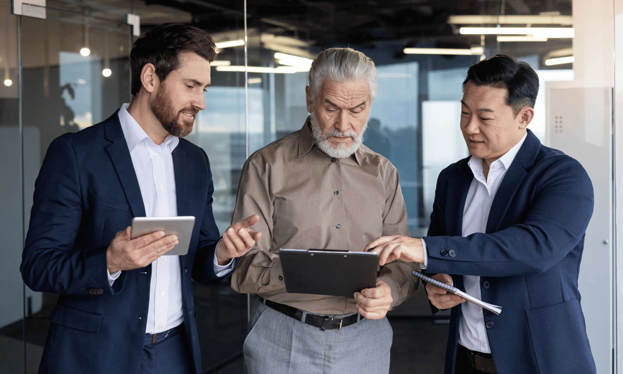 3 people looking at a piece of paper