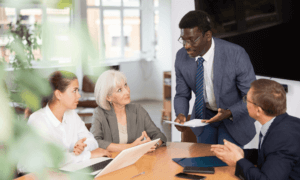 Four people discussing something sitting around a table