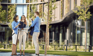 3 people standing around talking outside