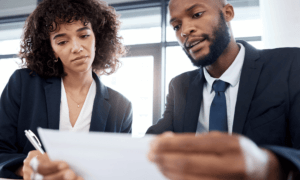 Two people looking at a piece of paper