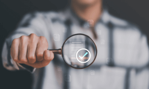 A person holding a magnified glass