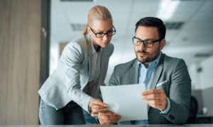 Two people looking at a piece of paper