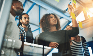 People planning out something using sticky note on a board