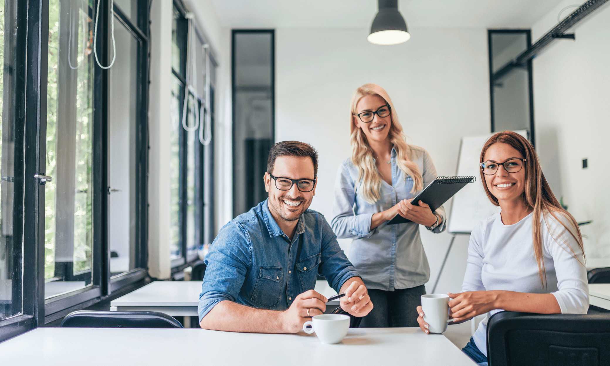 Three people smiling.