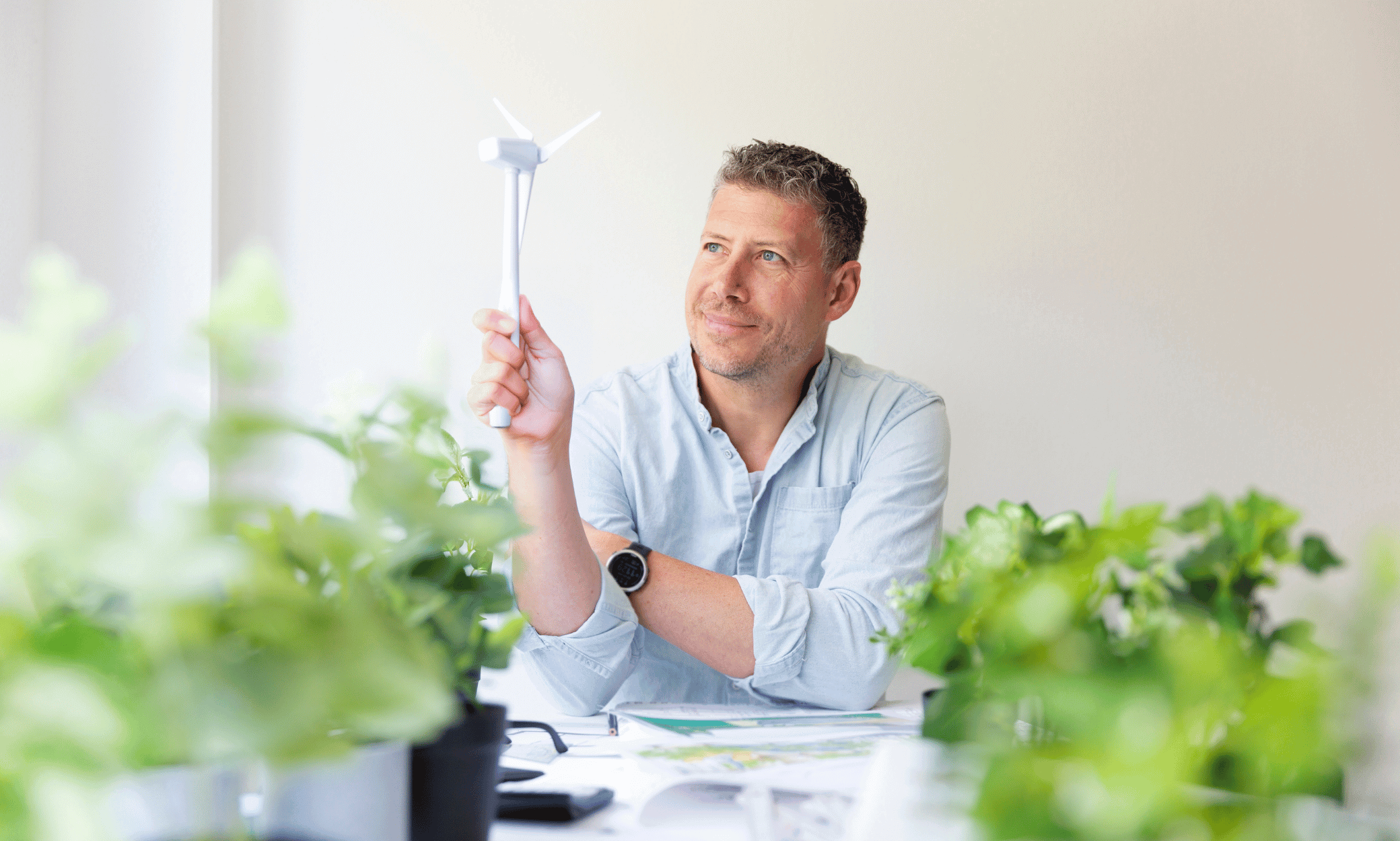 Someone holing a small wind mill.