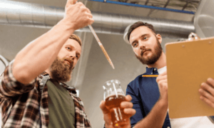 Two people testing beer.