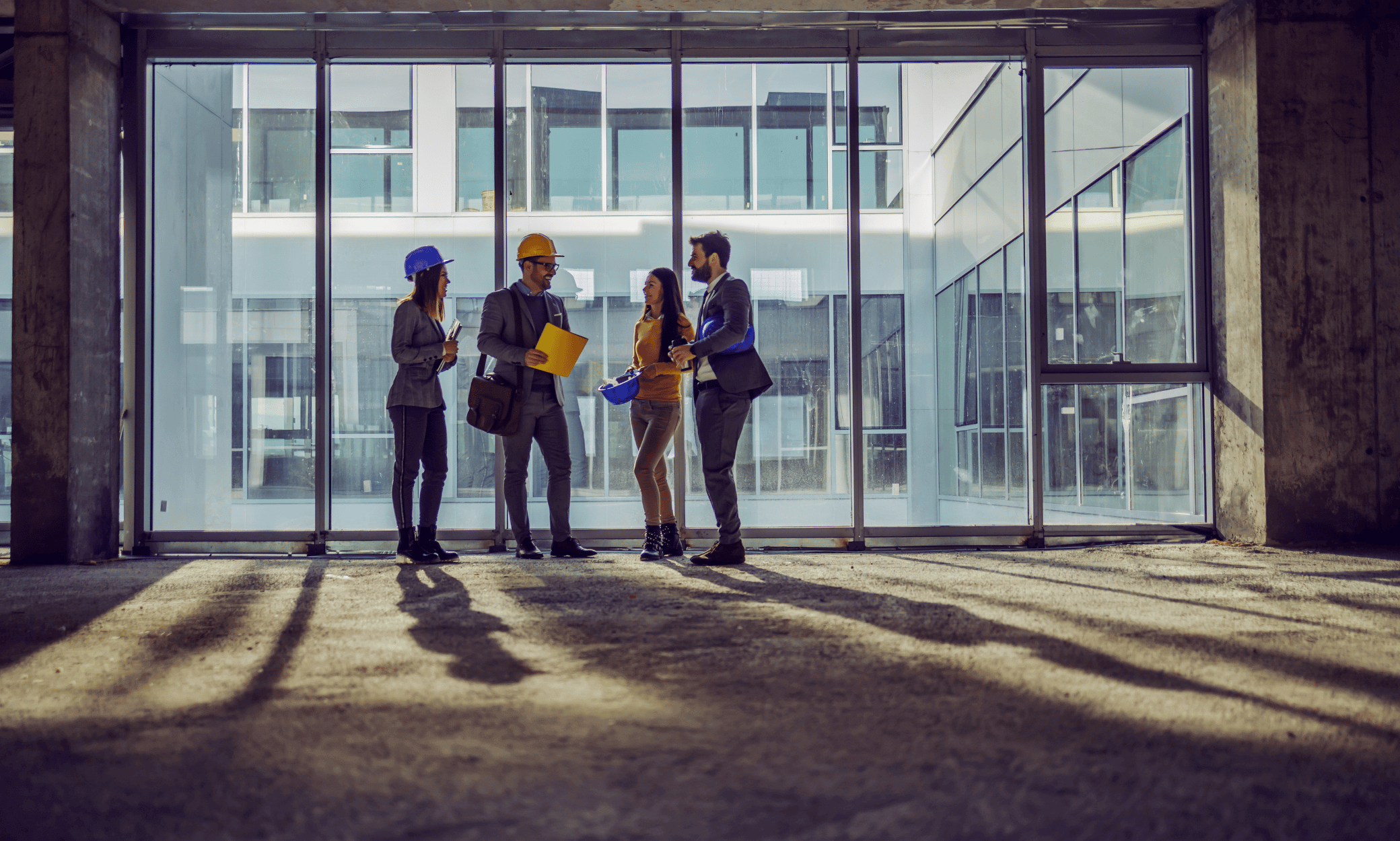 Four people standing inside an abandoned property.