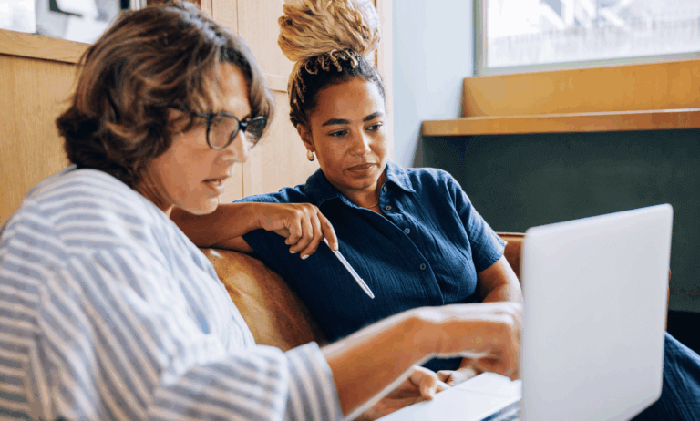 Two people looking at a laptop