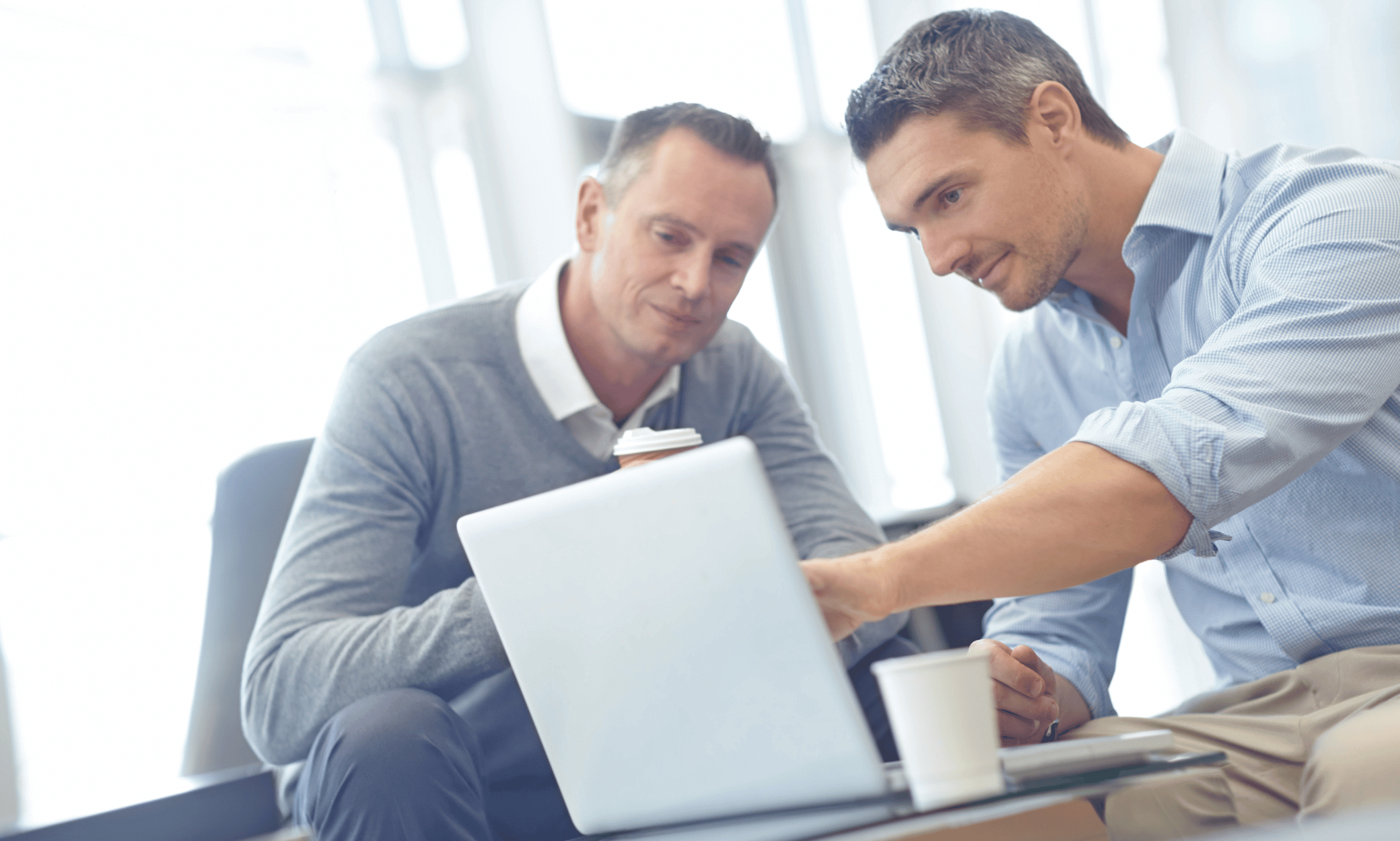 Two people looking at a computer.