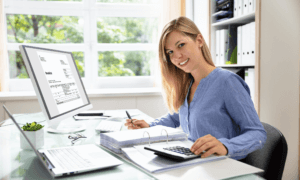 A happy person sitting in front of a computer