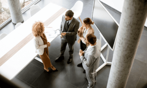 Four people standing around talking.