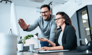 Two people looking at a computer