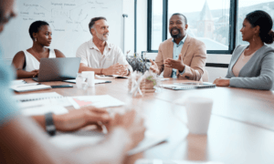 People in a conference room sitting around a table.