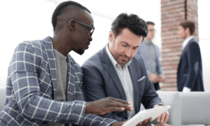 Two people looking at a tablet.