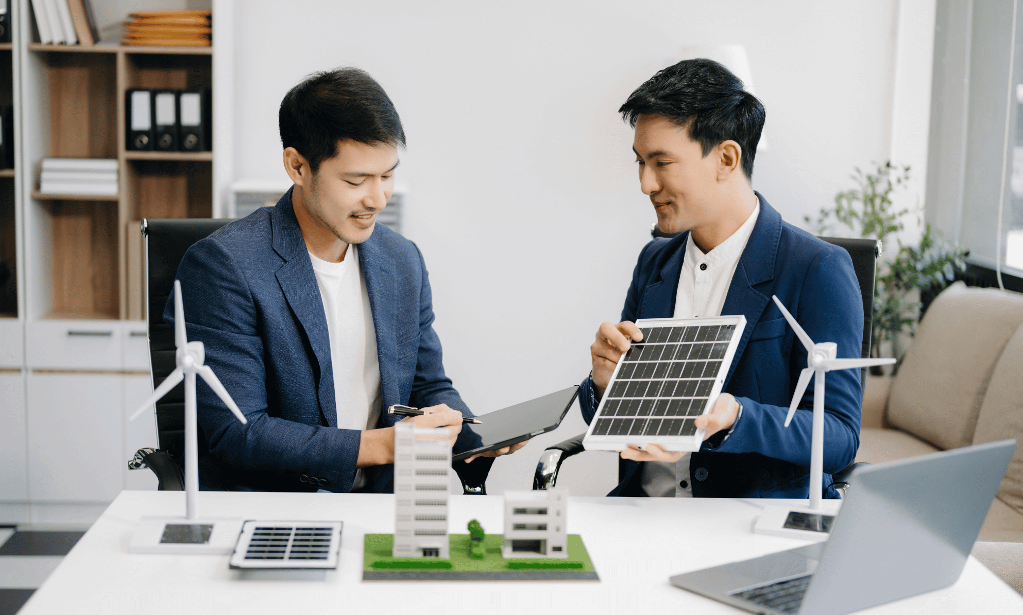 Two people and one of them is holding a solar panel.