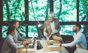 Four people talking about something sitting around a table.