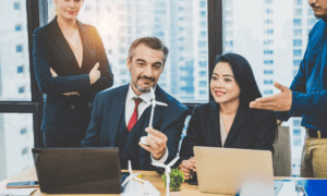 Business person holding a windmill.