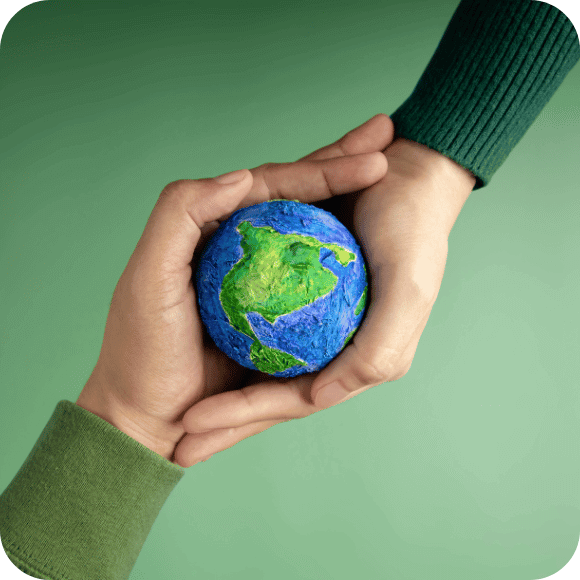 Two hands holding a globe
