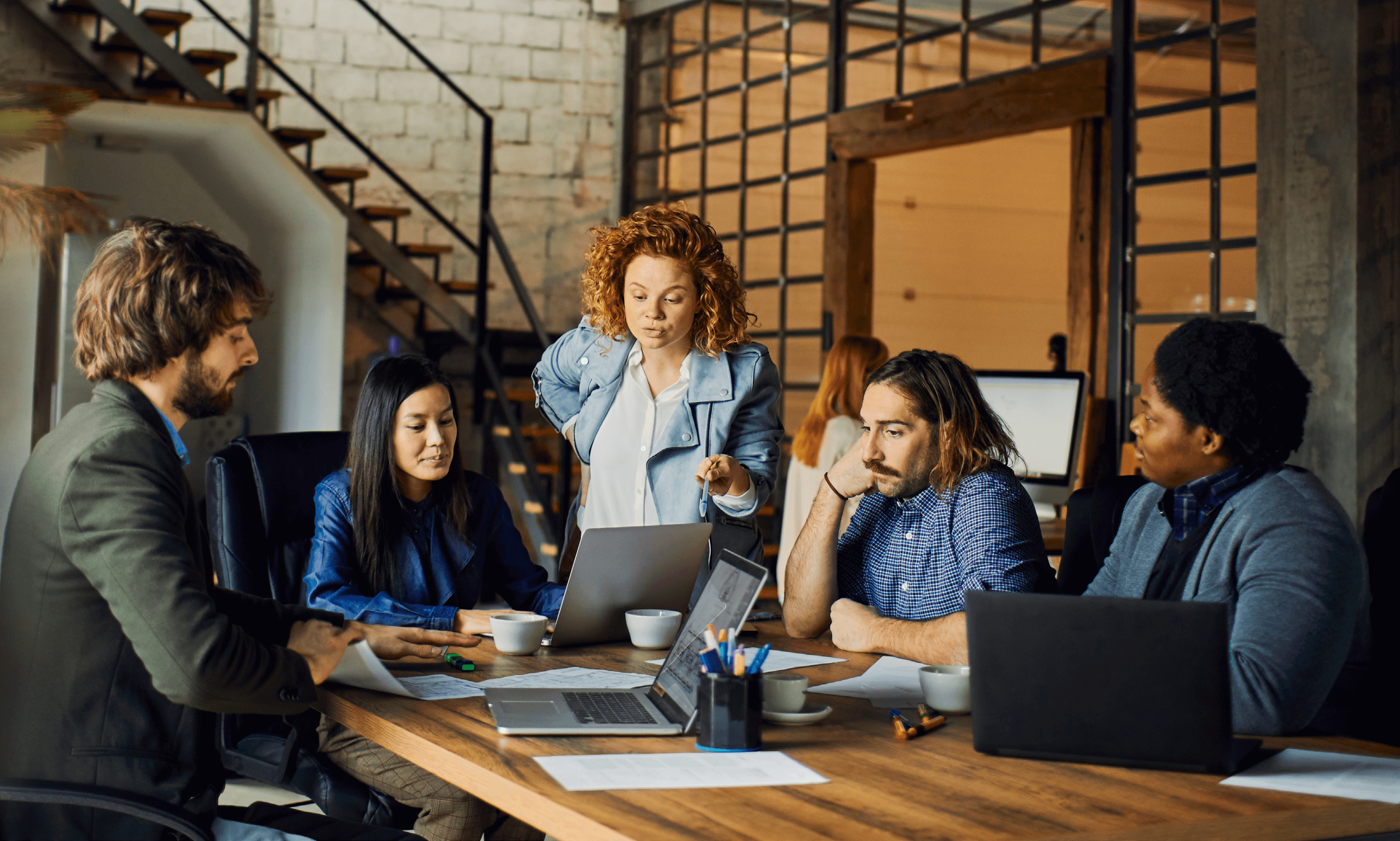 A group of people working around a table.