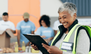 volunteer woman smiling while reading checklist