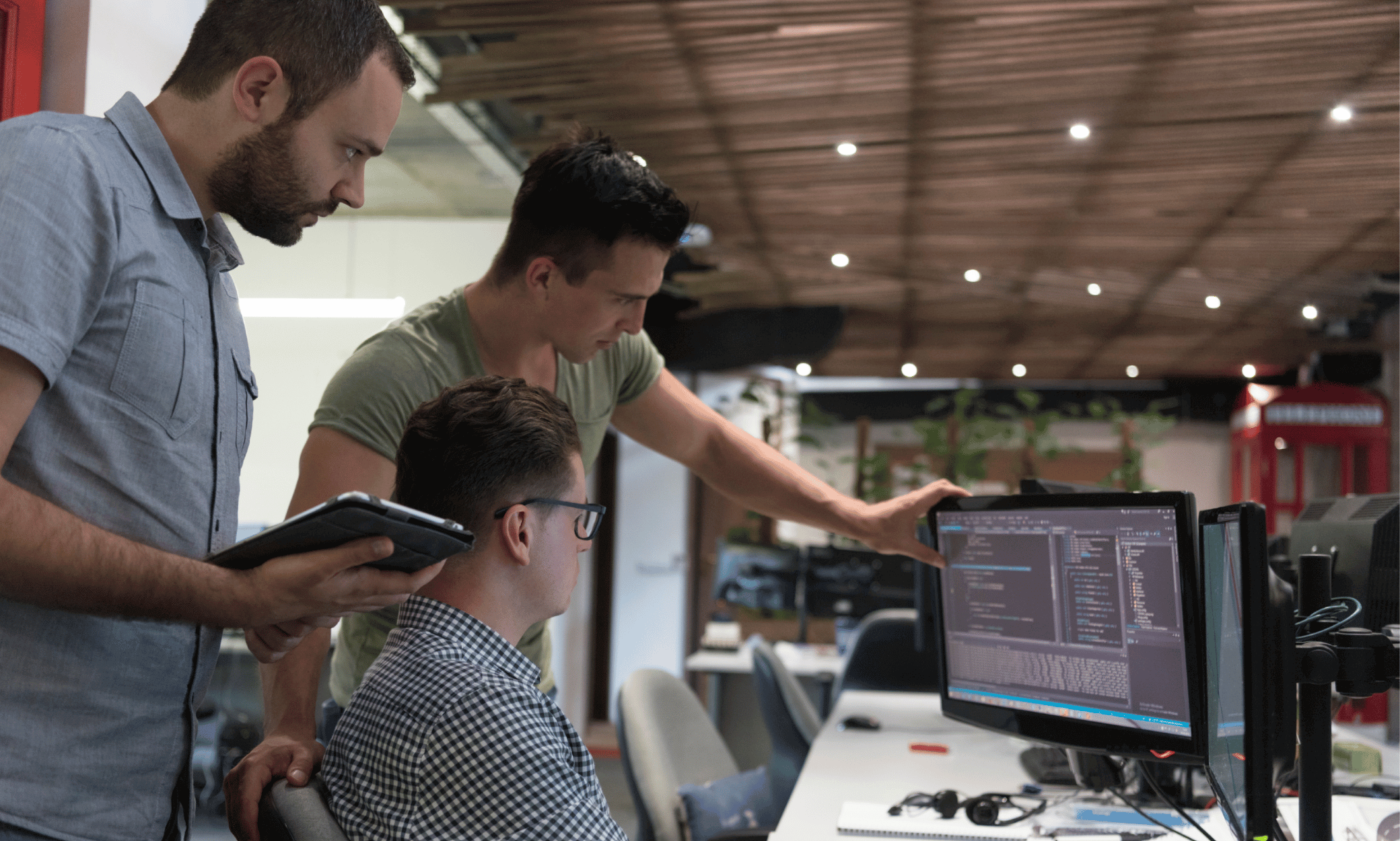 three people looking at computers