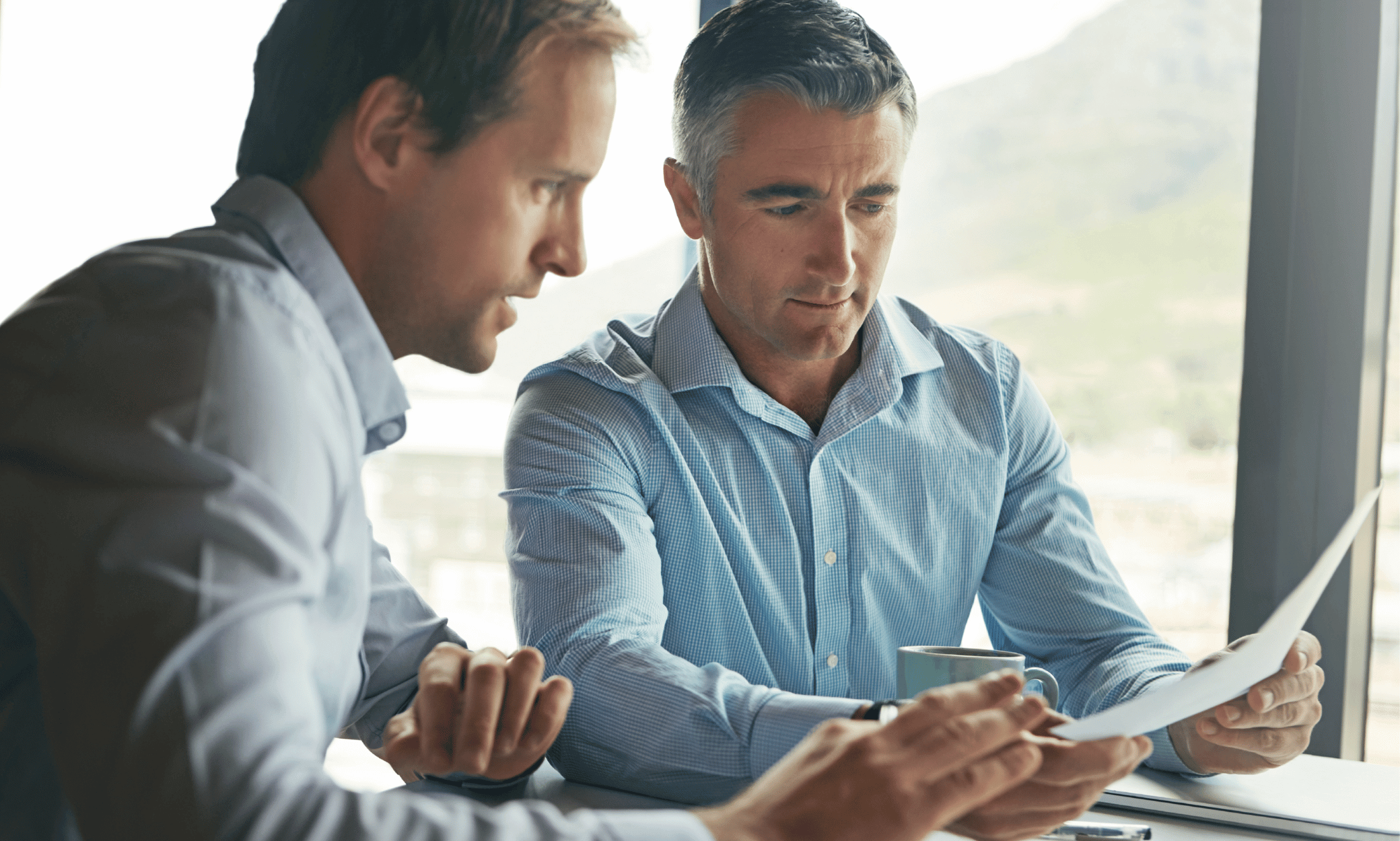 Two people looking at a paper