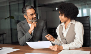 Two people discussing a document.