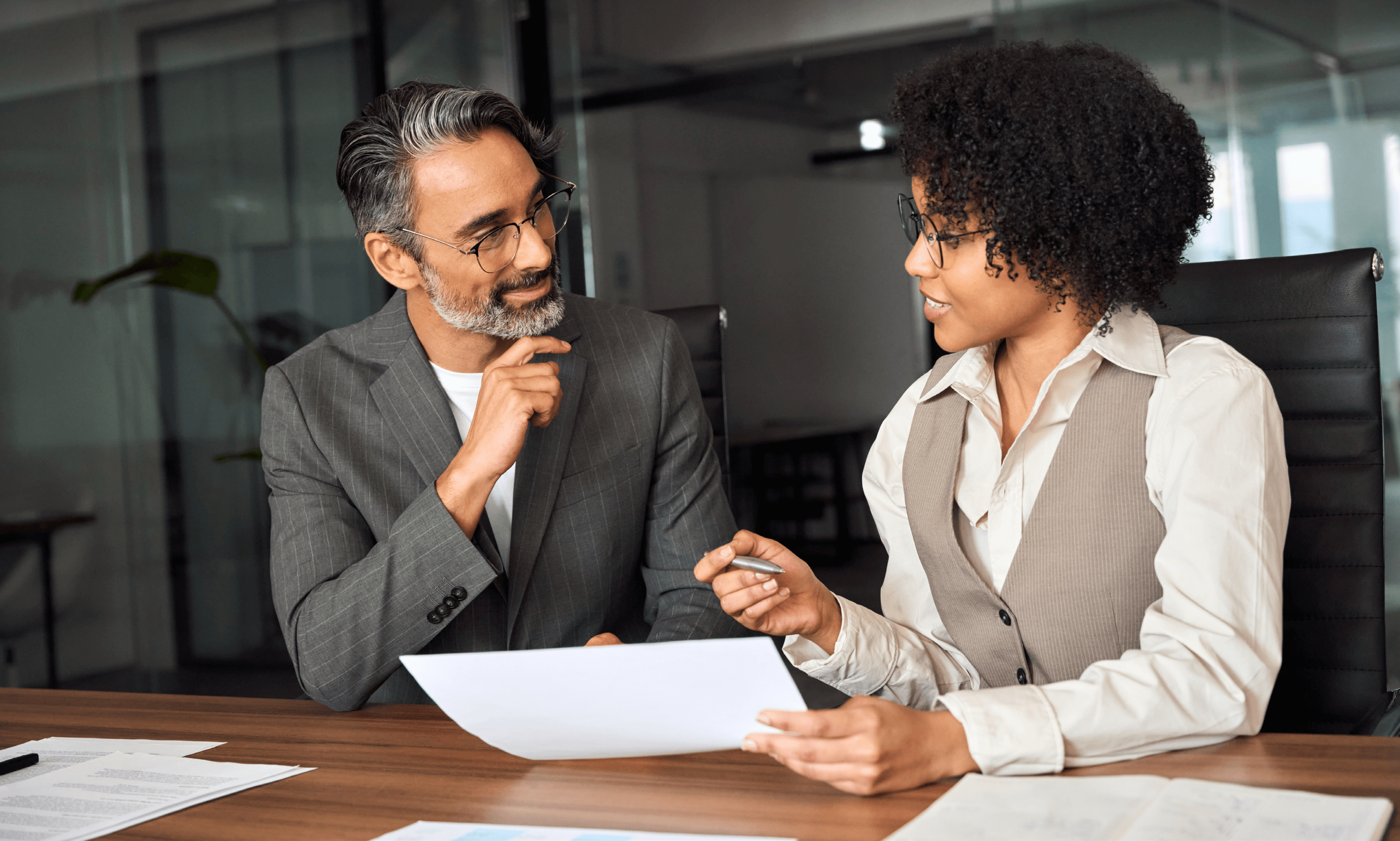 Two people discussing a document.