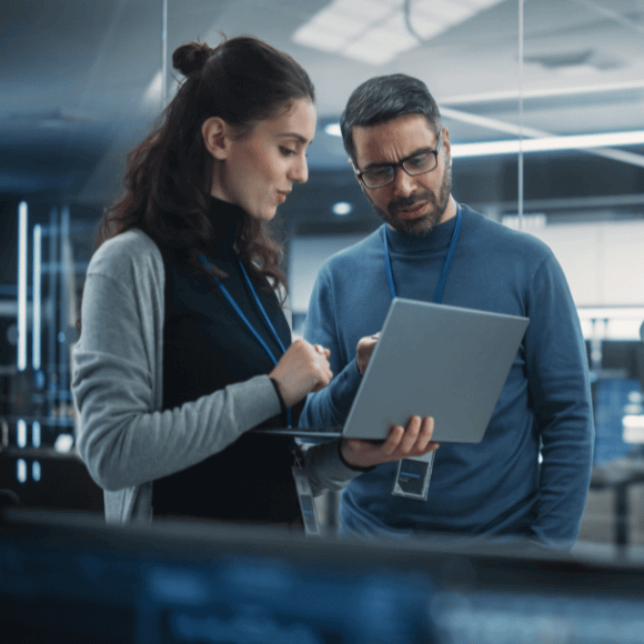 Two people looking at a laptop