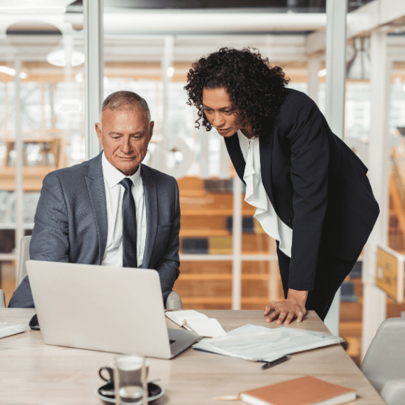 Two people looking at a laptop.