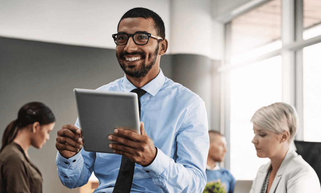 Person holding tablet and smiling.