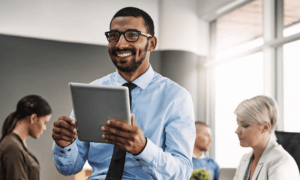 Person holding tablet and smiling.