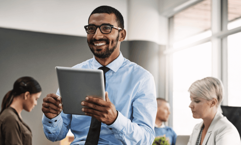 Person holding tablet and smiling.