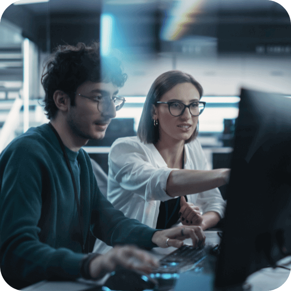 Two people looking at a computer.