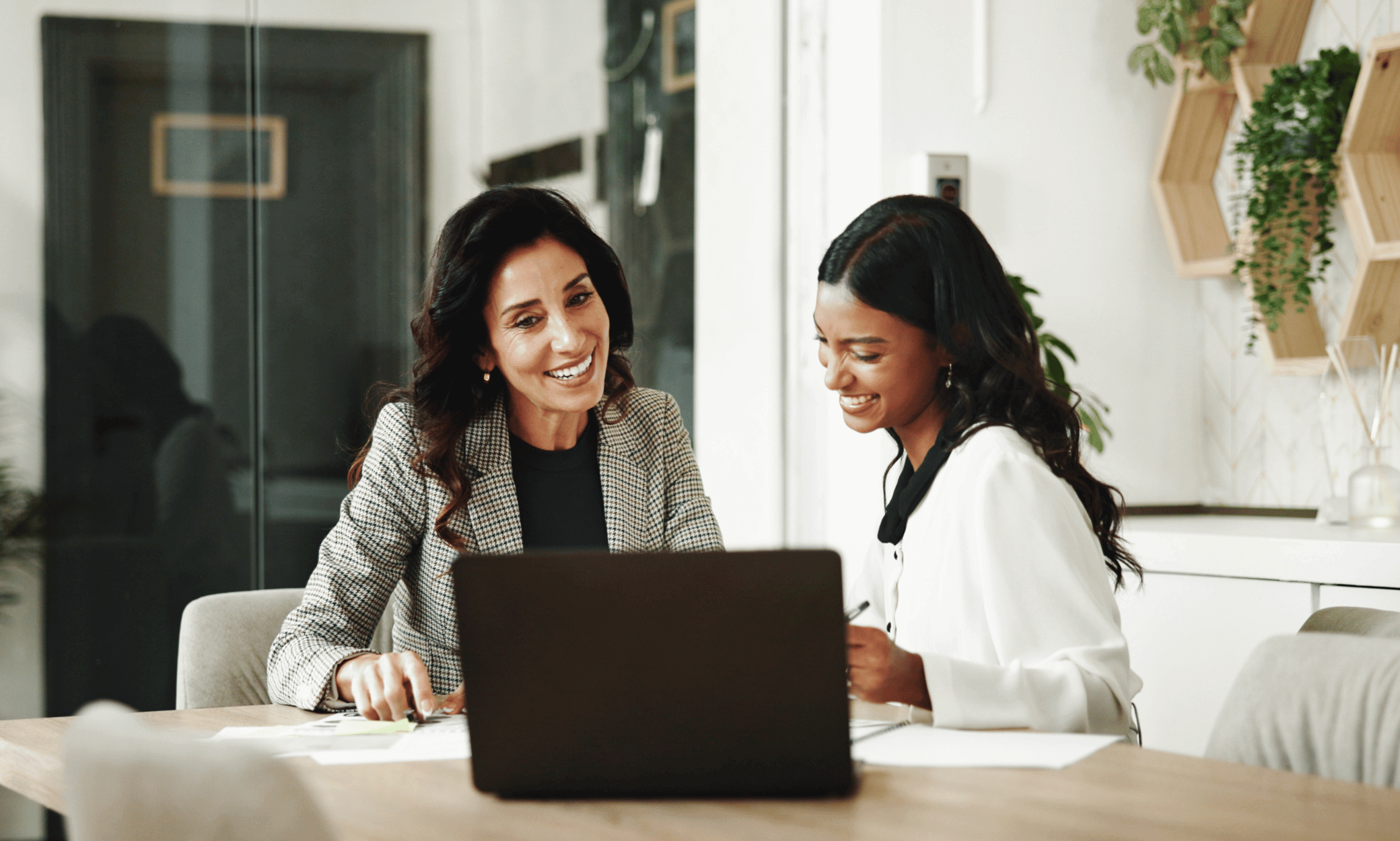 Two people looking at a laptop.