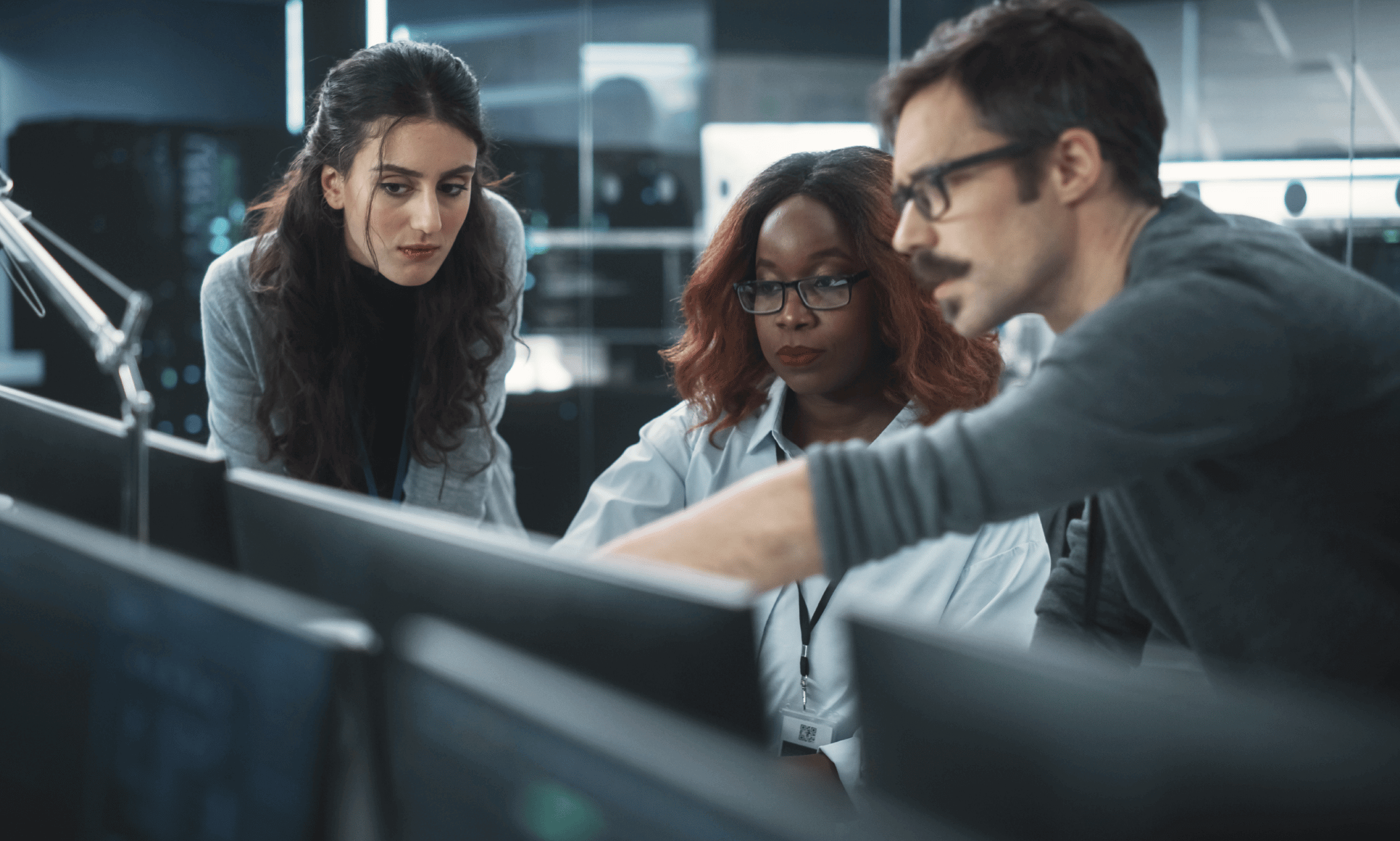 three people looking at a computer.
