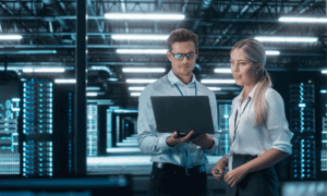two people looking at a laptop