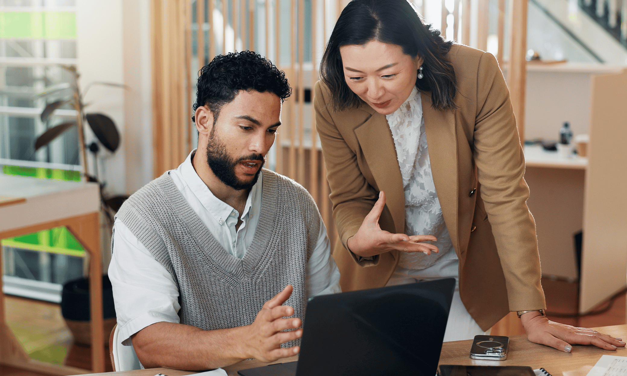 two people looking at a laptop