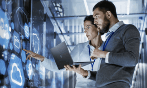 two people looking at a laptop
