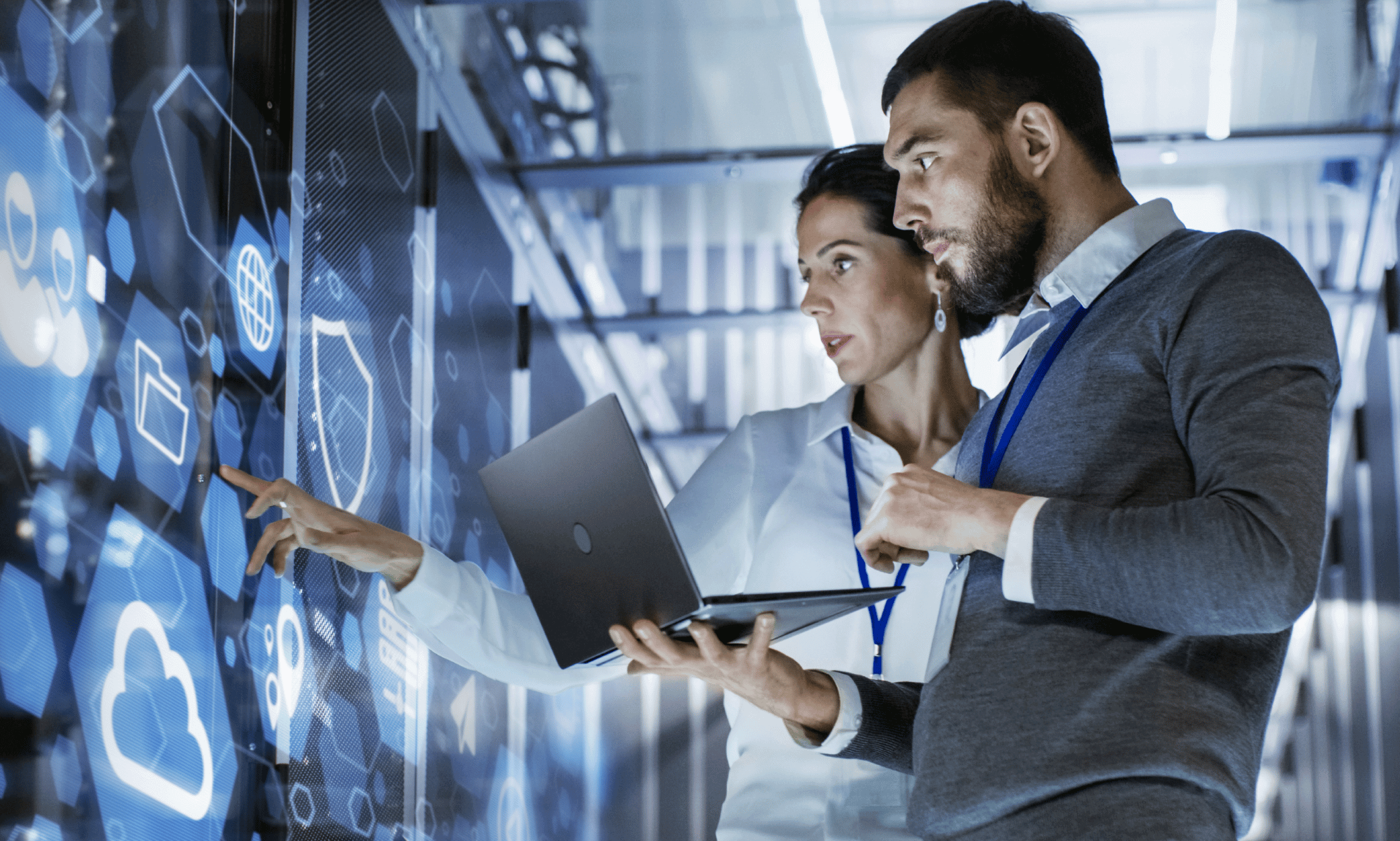two people looking at a laptop
