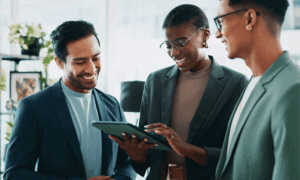 Three people looking at a tablet