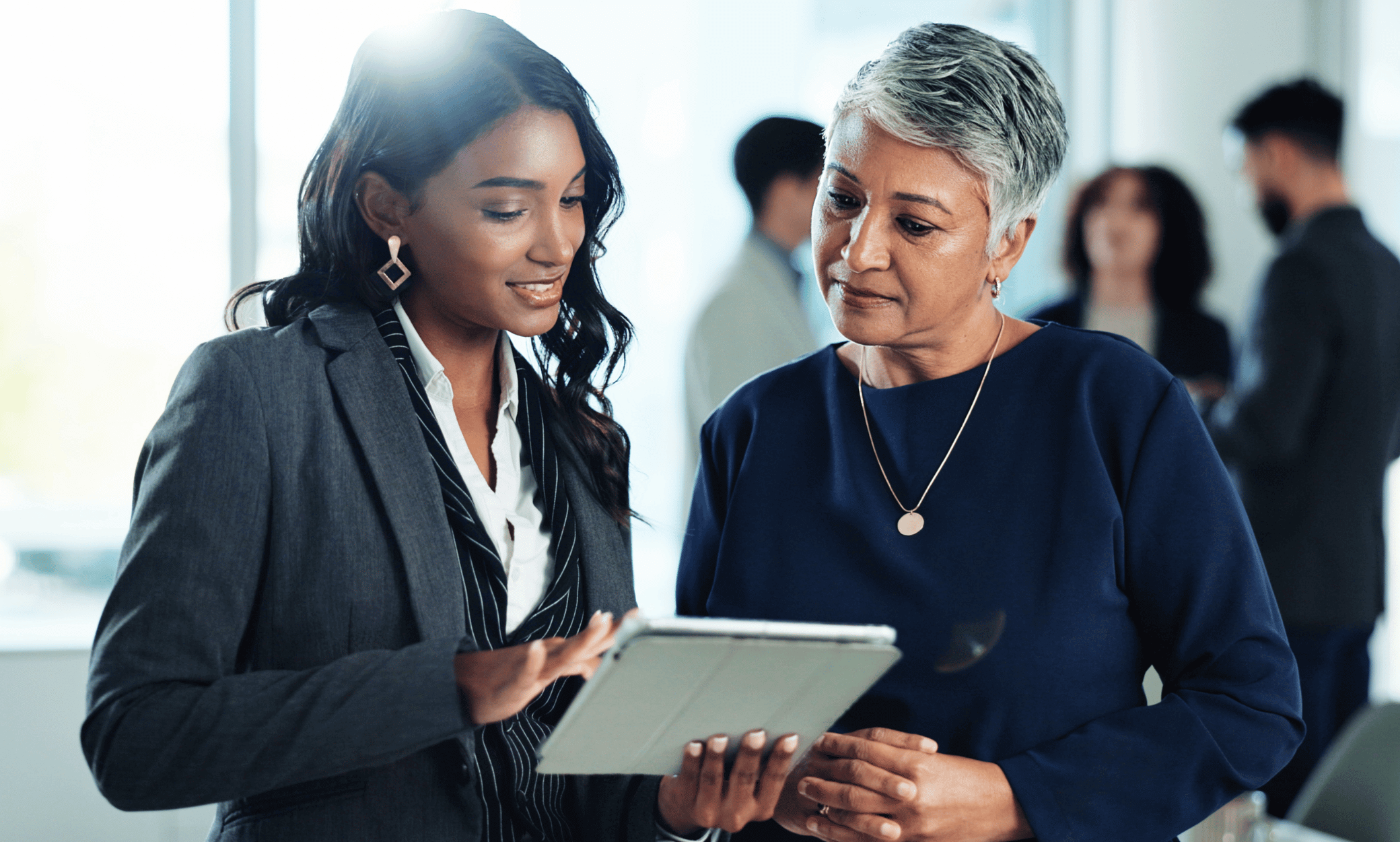 two people looking at a tablet