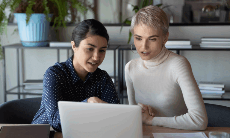 two people looking at a laptop and discussing.
