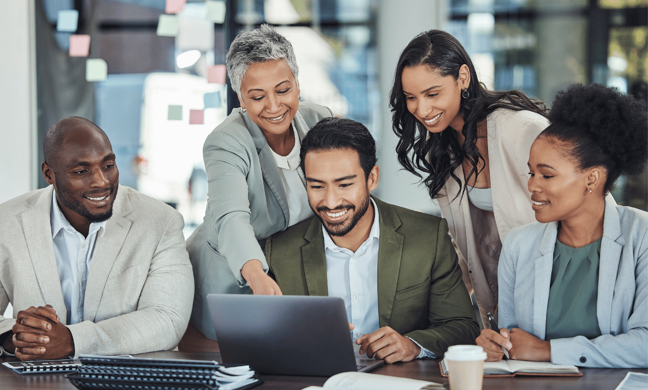 Five people looking at a tablet.