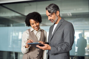 Two people looking at a tablet