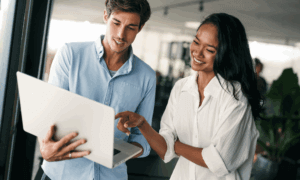 Two people looking at a laptop